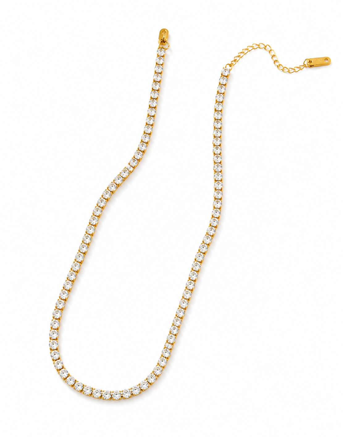 Gold crystal tennis necklace with continuous row of round cut stones in prong settings and adjustable extender chain, displayed on white background.