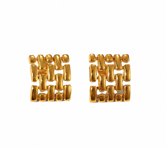 Chunky square gold stud earrings with raised geometric grid pattern and high-shine finish, displayed on neutral background.
