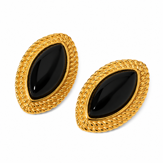 Oversized gold oval stud earrings with glossy black marquise centre stone and twisted rope border detail, displayed on white background.