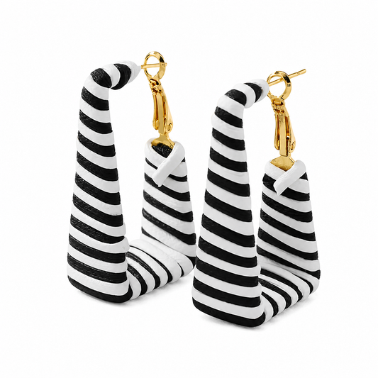 Black and white striped hand-woven twisted cone drop earrings with gold clasp hardware, shown as a pair on neutral background.