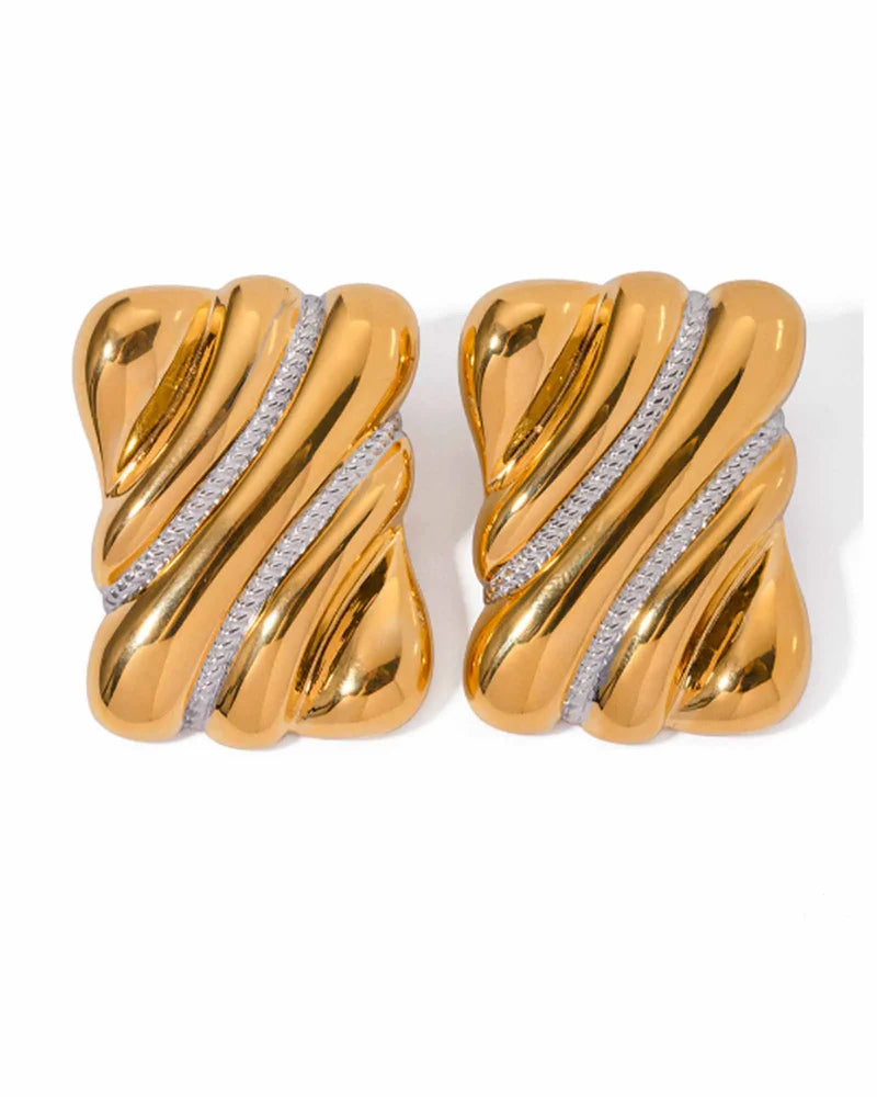 
Oversized chunky gold rectangle stud earrings with sculptural twisted ridges and diagonal crystal pave strips, displayed on white background.