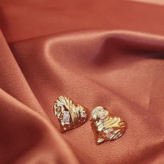 Stylish gold diamond heart statement stud earrings—perfect for making a sophisticated and minimalist statement